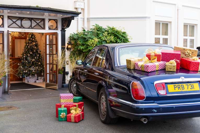 Rolls Royce with Christmas Gifts by Hotel Entrance 