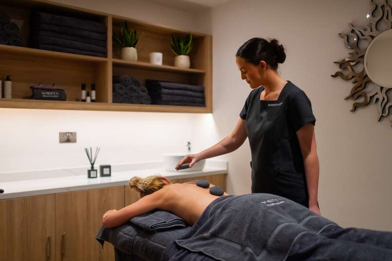 woman getting hot stone massage 