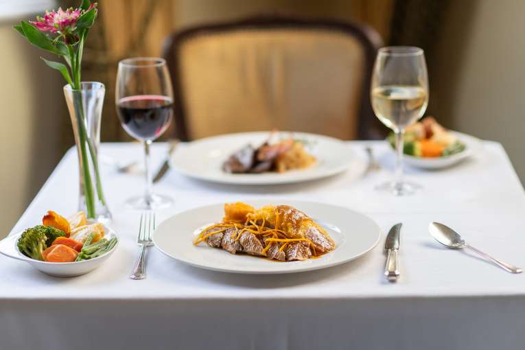 Duck dish with blurred dish in the background in The Jubilee Restaurant 