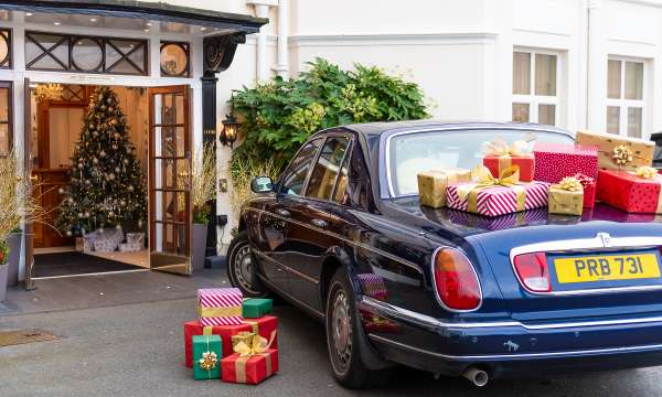 Rolls Royce with Christmas Gifts by Hotel Entrance 