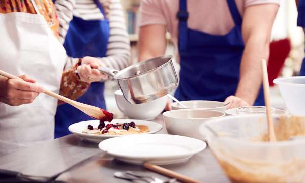 A Group making pancakes with berries