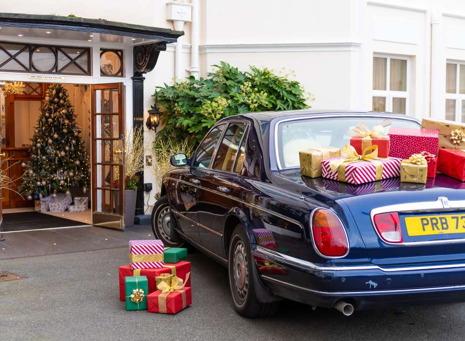 Rolls Royce with Christmas Gifts by Hotel Entrance 