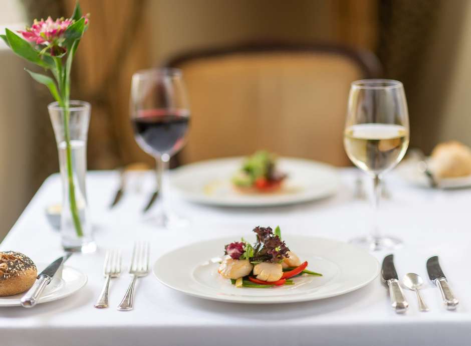 Scallop dish on a white plate in The Belmont Restaurant