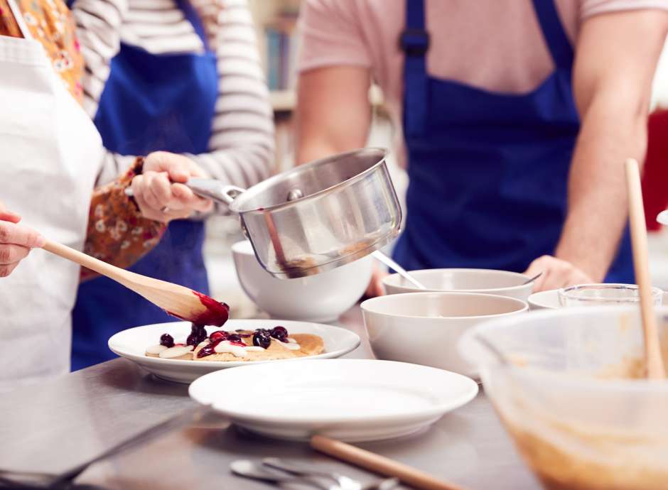 A Group making pancakes with berries
