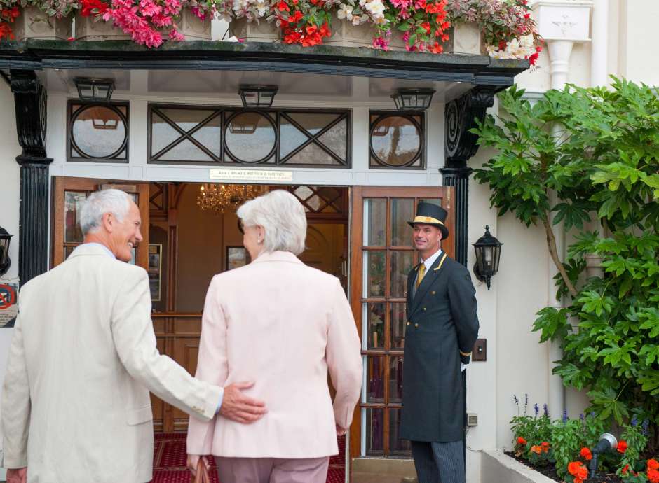 Belmont Hotel Doorman Greets Arriving Guests at Front Door